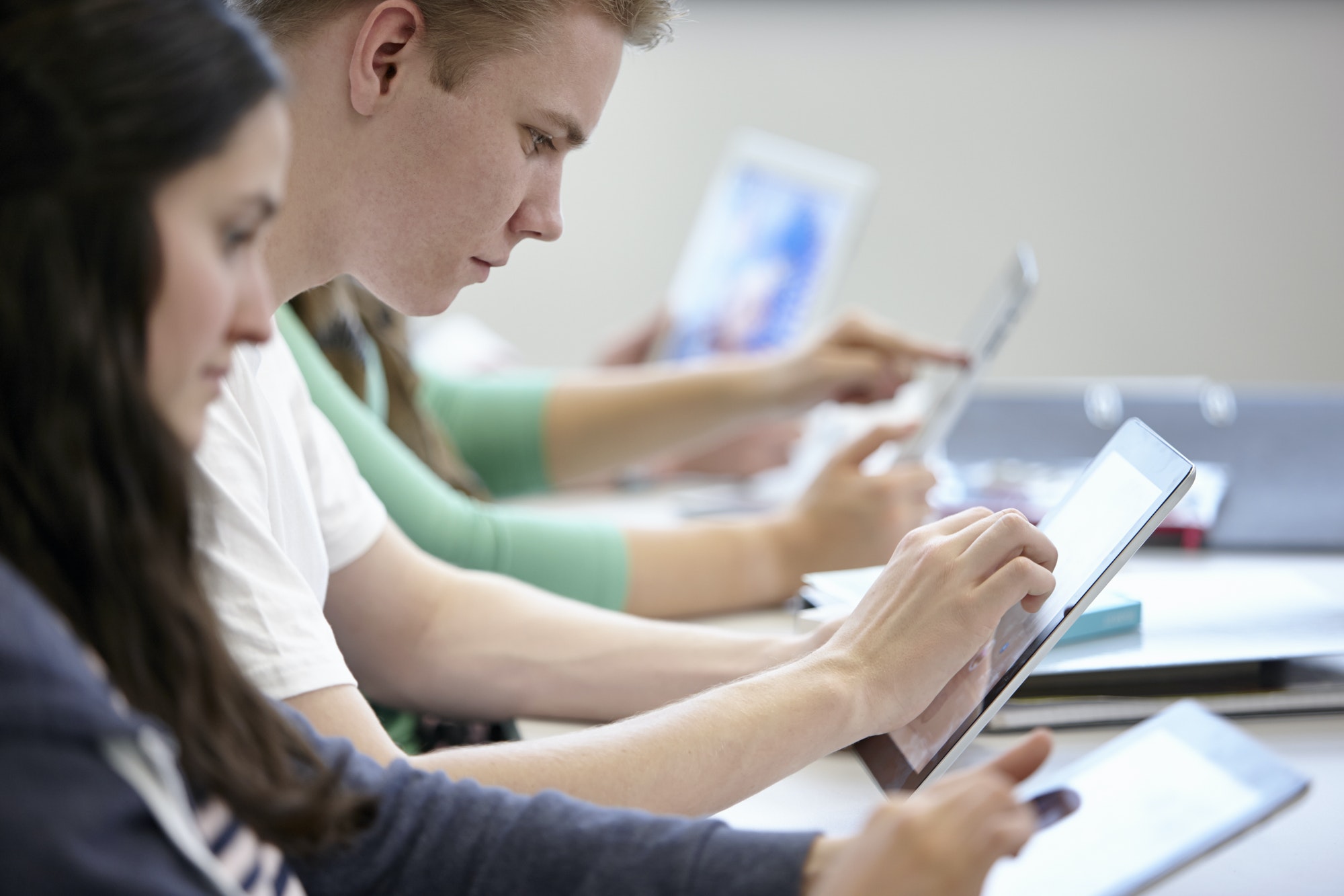 teenagers-using-digital-tablets-classroom